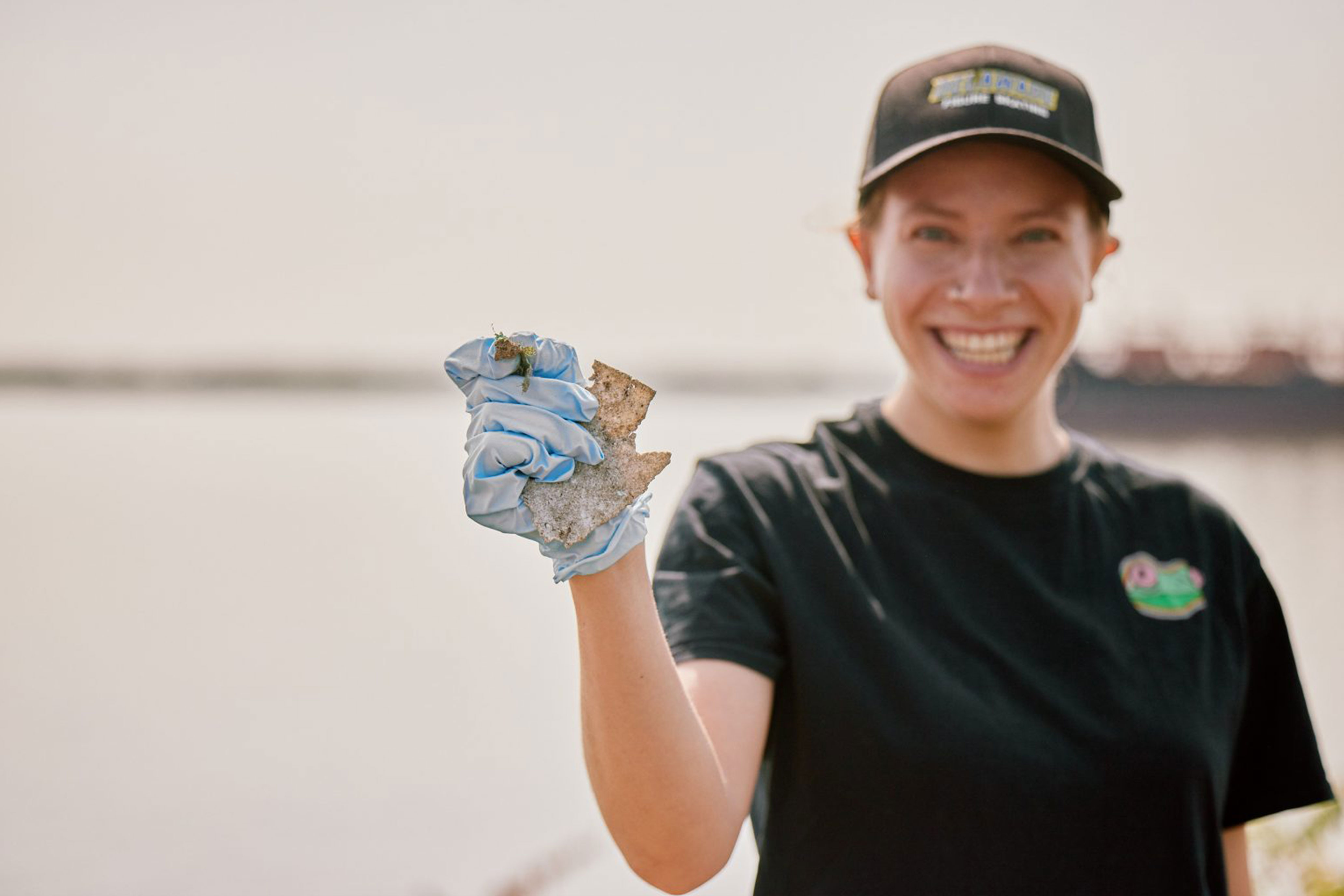 Person holding a piece of trash