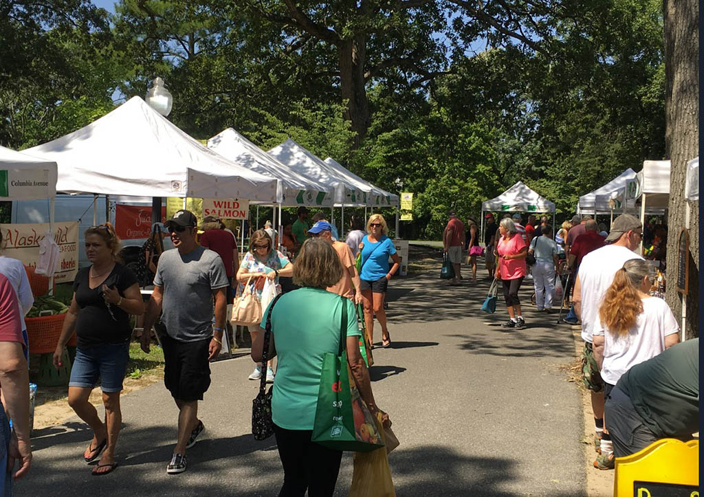 People outside at a local farmer's market.