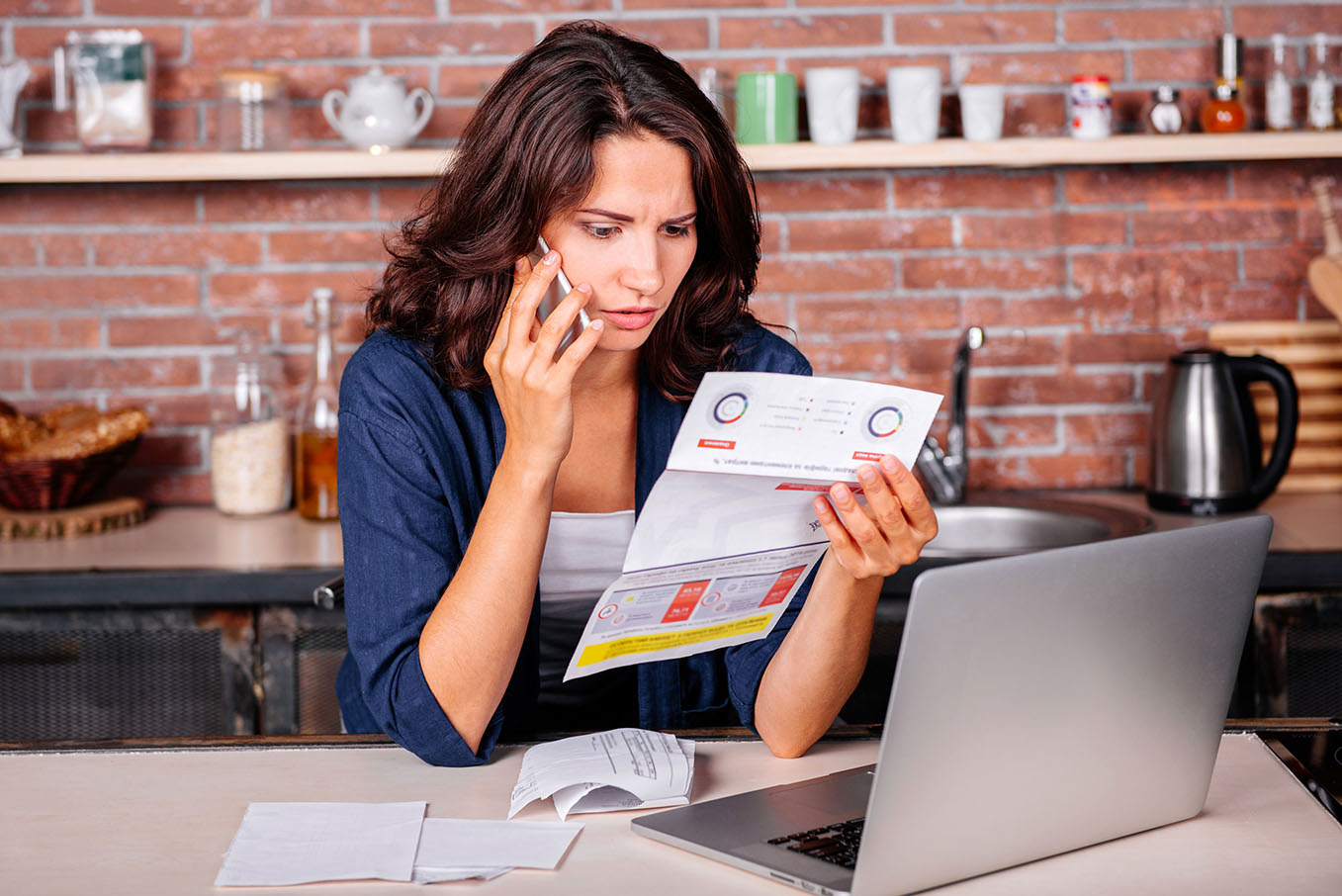 A picture of woman on the phone holding a document